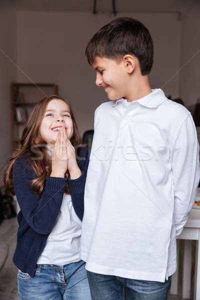 Cheerful little boy and girl laughing together Stock photo © deandrobot