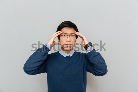 Jungen business woman Kopfschmerzen Anzug isoliert grau Stock foto © deandrobot