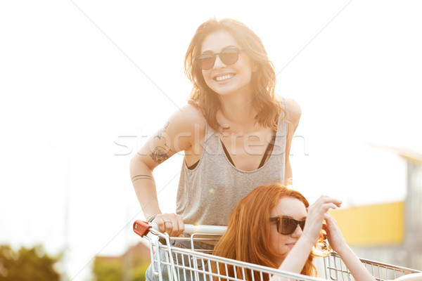 Two laughing crazy women in sunglasses having fun Stock photo © deandrobot