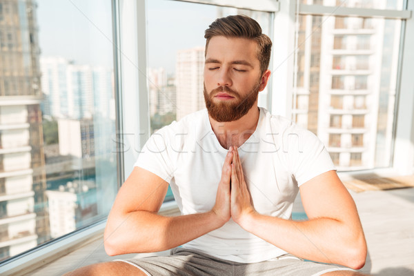 Barbudo homem meditação janela casa Foto stock © deandrobot