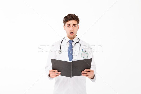 Portrait of an astonished young male doctor Stock photo © deandrobot