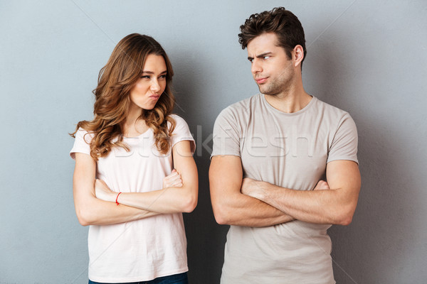 Upset disappointed couple standing with arms Stock photo © deandrobot