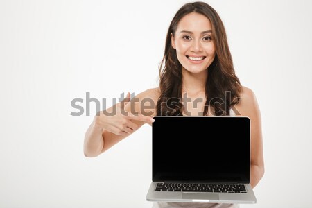 Stock photo: Horizontal photo of happy woman 30s smiling and demonstrating bl