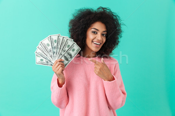 Portrait of excited woman 20s with afro hairstyle pointing finge Stock photo © deandrobot