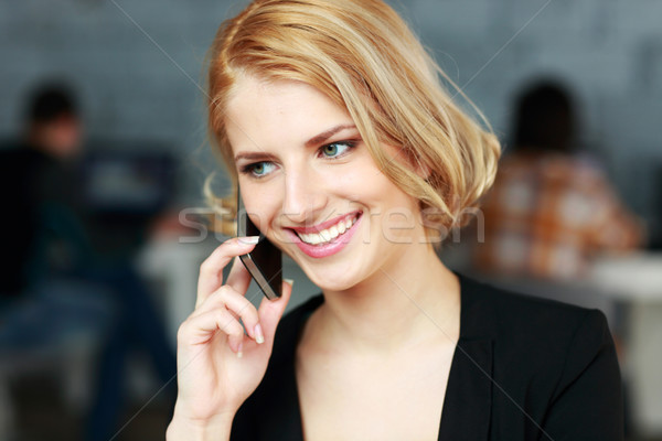 Femme d'affaires parler téléphone bureau [[stock_photo]] © deandrobot