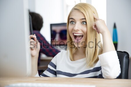 Angry woman working on compute Stock photo © deandrobot