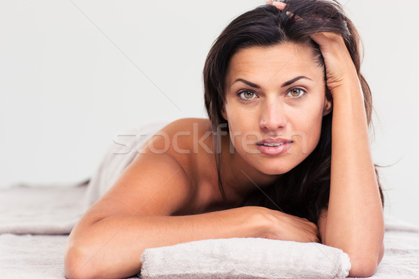 Beautiful woman lying on massage lounger  Stock photo © deandrobot