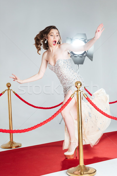 Woman falling on red carpet Stock photo © deandrobot