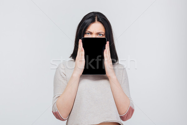 Brunette pretty girl cover her face with tablet pc Stock photo © deandrobot