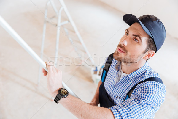 Stock photo: Close-up portrait of a decorator using roller in work