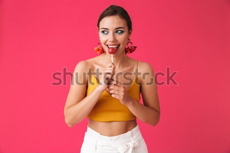 Portrait of a sexy young brunette wearing bikini holding cocktail Stock photo © deandrobot