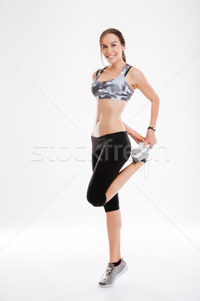 Full length aerobic woman warming up Stock photo © deandrobot