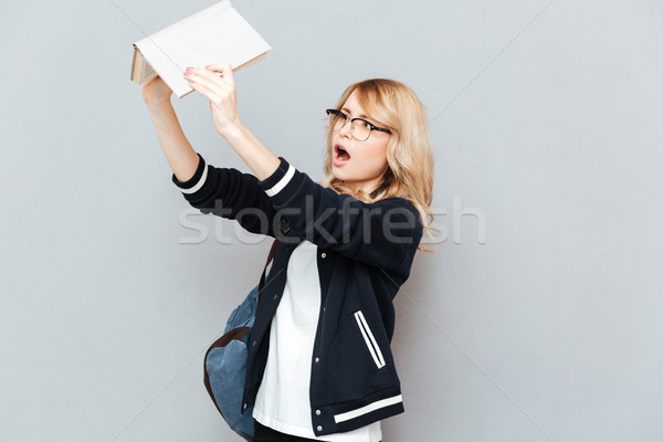 Student looking at book Stock photo © deandrobot