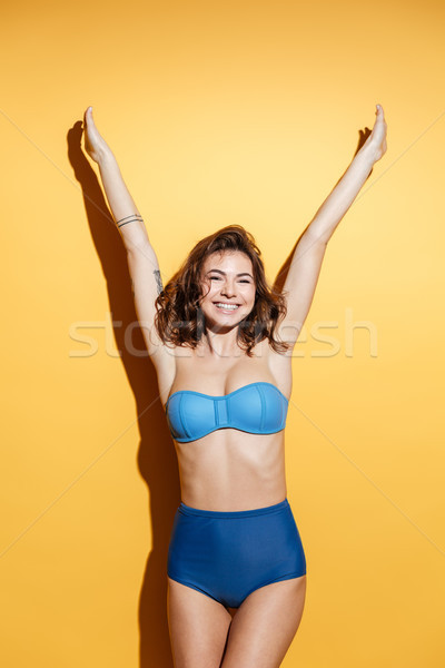 Happy young woman in swimwear isolated Stock photo © deandrobot