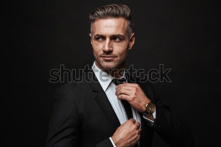 Concentrated young man dressed in formalwear Stock photo © deandrobot