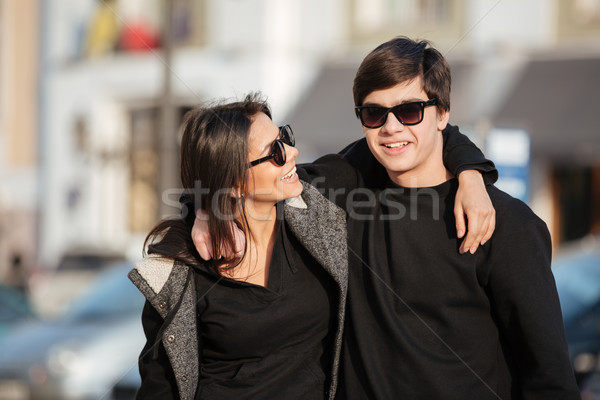 Happy young woman walking outdoors with her brother Stock photo © deandrobot
