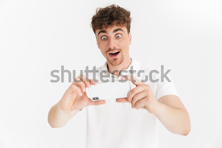 Shocked young lady wearing scarf chatting by mobile phone. Stock photo © deandrobot