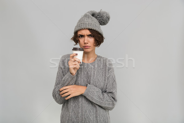 Sad displeased young woman drinking coffee. Stock photo © deandrobot