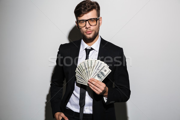 Portrait of a confident successful man in suit and eyewear Stock photo © deandrobot