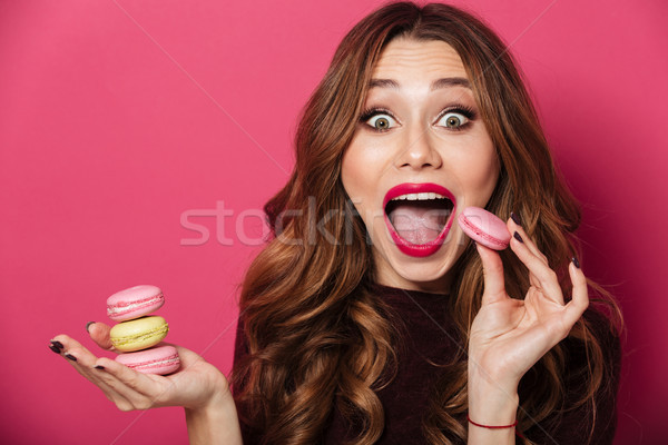 Surprised lady eating macaroons. Stock photo © deandrobot