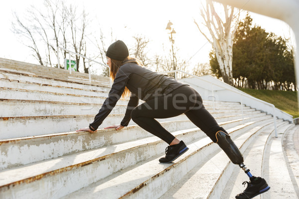 Image of disabled running girl with prosthetic leg in sportswear Stock photo © deandrobot