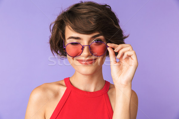 Smiling Pretty brunette woman in sunglasses winks her eye Stock photo © deandrobot