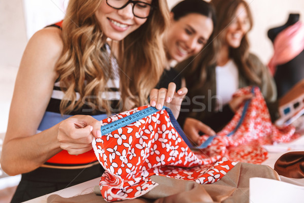 Cropped image of three cheerful young women Stock photo © deandrobot