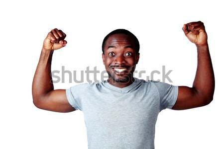 Portrait of african man with raised hands over white background Stock photo © deandrobot