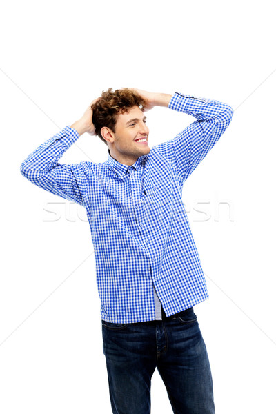 Smiling man standing over white background Stock photo © deandrobot