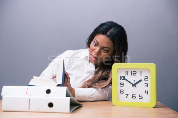 African businesswoman sitting at the table with book Stock photo © deandrobot