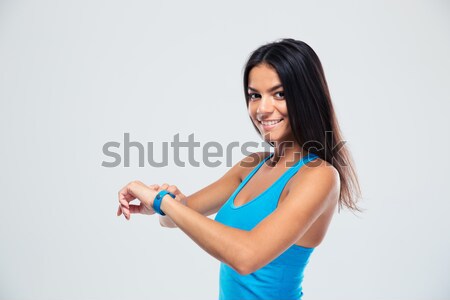 Cheerful fitness woman using fitness tracker Stock photo © deandrobot
