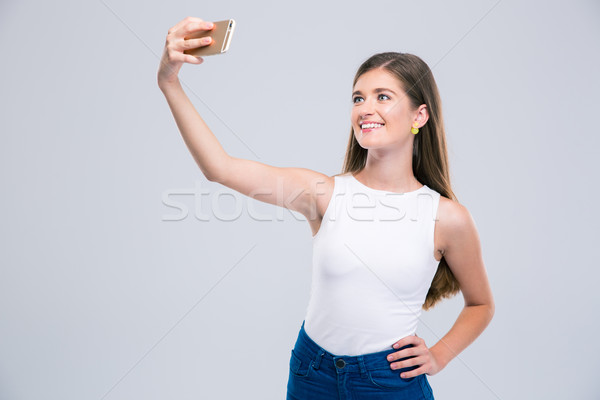 Smiling female teenager making selfie photo Stock photo © deandrobot