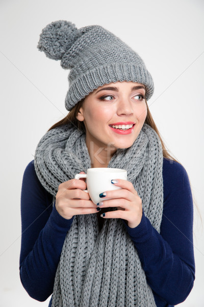 Woman in winter cloth holding cup with coffee Stock photo © deandrobot