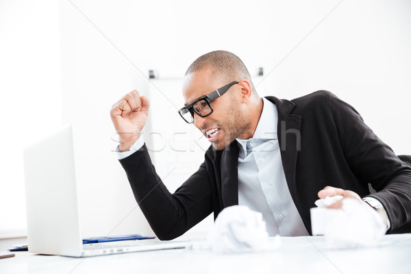 Businessman working at office desk overloaded with paperwork Stock photo © deandrobot