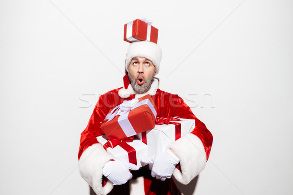 Funny man santa claus with gift boxes having fun Stock photo © deandrobot