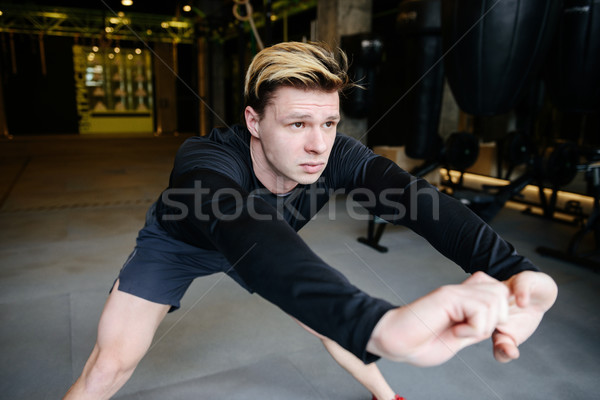 Serious Athletic man warming up Stock photo © deandrobot