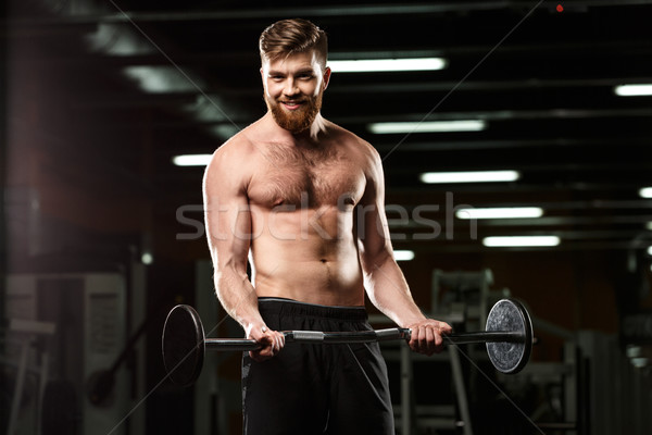Sonriendo deportes hombre deporte barra con pesas Foto stock © deandrobot