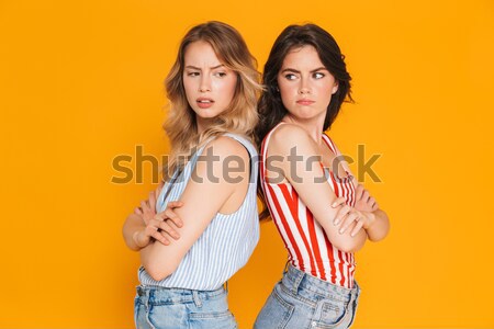 Shocked young ladies looking at phone. Stock photo © deandrobot