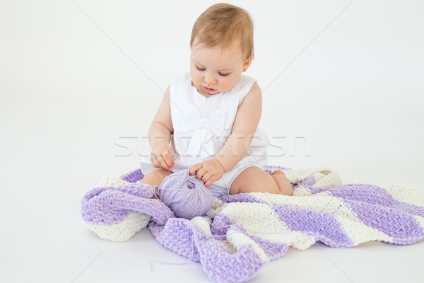 Little baby girl playing with threads ball. Stock photo © deandrobot