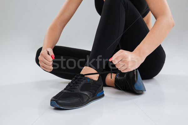 Cropped image of fitness woman sitting on the floor Stock photo © deandrobot