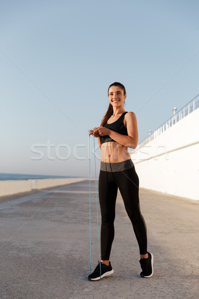 Beautiful cheerful woman with jumping rope training isolated Stock photo © deandrobot