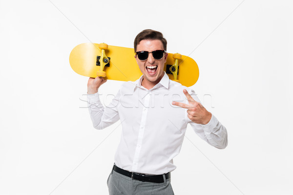 Portrait of a cheerful amused man in white shirt Stock photo © deandrobot