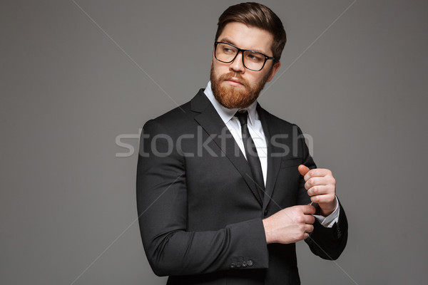 Portrait of a confident young businessman dressed in suit Stock photo © deandrobot