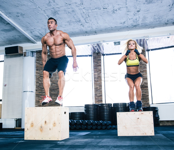 Group of man and woman working out with fit box Stock photo © deandrobot