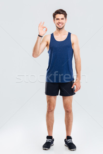 Teljes alakos portré fitnessz férfi mutat oké Stock fotó © deandrobot