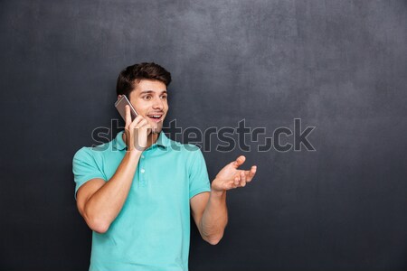 [[stock_photo]]: Souriant · séduisant · jeune · homme · permanent · parler · téléphone · portable