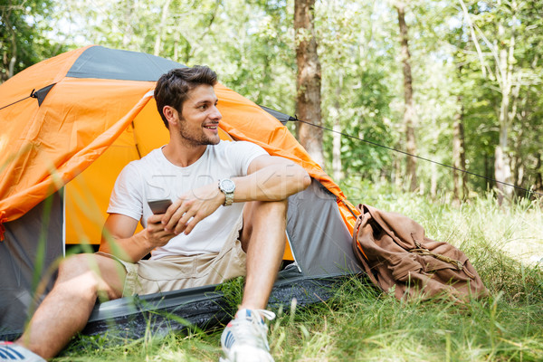 человека туристических сидят палатки сотового телефона Сток-фото © deandrobot