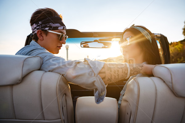 Beautiful young couple sitting in cabriolet in summer Stock photo © deandrobot