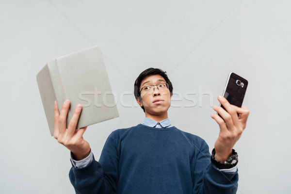 Stock photo: Asian student with book and phone