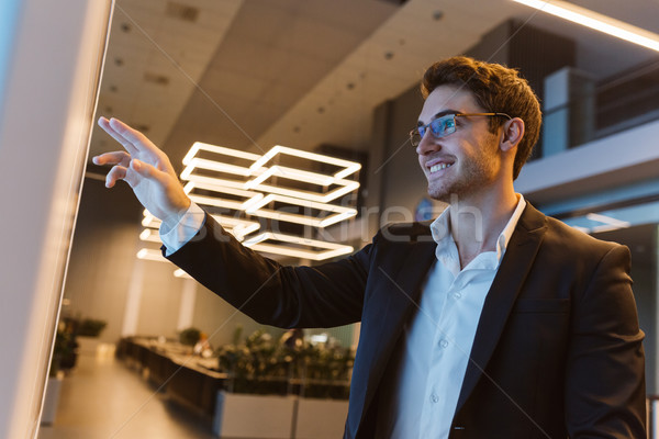 Smiling Business man in glasses Stock photo © deandrobot